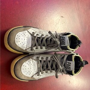 P448 White and Gray High-Top with Yellow Trim originally owned by Cara Delevinge